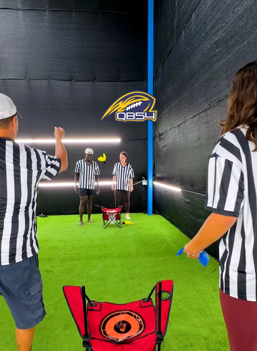 Friends in referee jerseys tossing REF54 flags at a QB54 chair target
